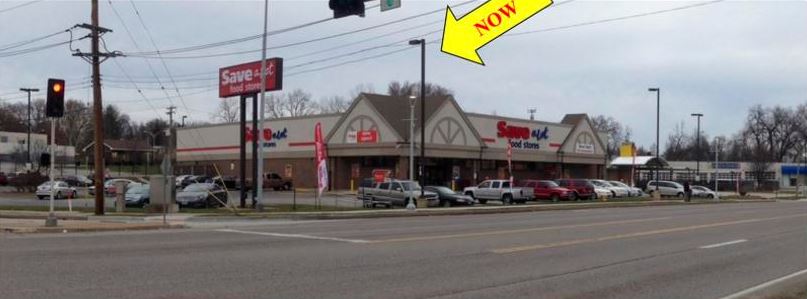 A store front with a large yellow arrow pointing to the right.