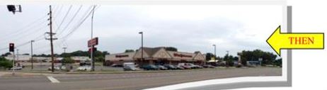 A large parking lot with cars parked on the side of it.